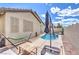 Backyard oasis featuring a private pool and spa, ideal for outdoor enjoyment and relaxation, with lounge and hammock at 344 Golden Shore Dr, Las Vegas, NV 89123