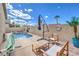Private backyard with a refreshing pool and spa, complete with comfortable seating for relaxation and entertaining guests at 344 Golden Shore Dr, Las Vegas, NV 89123