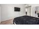 View of the bedroom showing the TV, bathroom entrance, and dining room through the open door at 3515 Cactus Shadow St # 202, Las Vegas, NV 89129