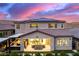 Stunning backyard with covered patio, outdoor kitchen, and solar panels against a colorful dusk sky at 3929 Reyes Ave, Las Vegas, NV 89141
