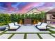 Beautiful backyard setting with lush greenery, comfortable seating, and a serene outdoor living space at 3929 Reyes Ave, Las Vegas, NV 89141