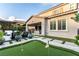 Charming backyard with a putting green, patio, and lush greenery at 3929 Reyes Ave, Las Vegas, NV 89141