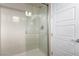 Bathroom featuring a glass enclosed shower with chrome hardware, and a white door at 3929 Reyes Ave, Las Vegas, NV 89141