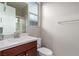 Bathroom featuring a vanity with a white countertop, sink, mirror, and a window at 3929 Reyes Ave, Las Vegas, NV 89141