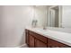 Bathroom vanity with dark wood cabinets, white countertops, a sink, and a large mirror at 3929 Reyes Ave, Las Vegas, NV 89141