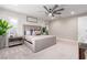 This well-lit primary bedroom features a large ceiling fan, a king bed, and neutral tones at 3929 Reyes Ave, Las Vegas, NV 89141
