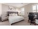 Inviting bedroom featuring a tufted headboard, ambient lighting, and a functional workspace at 3929 Reyes Ave, Las Vegas, NV 89141