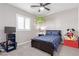 Cozy bedroom with a whimsical dinosaur decoration and ample space for play and rest at 3929 Reyes Ave, Las Vegas, NV 89141