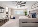 This well-lit primary bedroom offers great natural light, a large ceiling fan, and a comfortable upholstered bed at 3929 Reyes Ave, Las Vegas, NV 89141