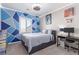 Stylish bedroom featuring a geometric accent wall, a modern bed, and a dedicated gaming setup at 3929 Reyes Ave, Las Vegas, NV 89141