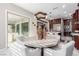 Open concept dining area featuring a modern light fixture and sliding glass door to the backyard at 3929 Reyes Ave, Las Vegas, NV 89141