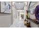 Hallway view with white tile flooring and decorations on a console table at 3929 Reyes Ave, Las Vegas, NV 89141