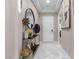 Bright entryway with white tile flooring, a decorative console table, and a round mirror at 3929 Reyes Ave, Las Vegas, NV 89141