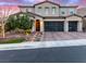 Beautiful two-story home featuring a two-car garage and professionally landscaped front yard with charming walkway lighting at 3929 Reyes Ave, Las Vegas, NV 89141
