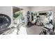 Well-equipped home gym with mirrored walls, modern equipment, and outdoor access, providing a convenient workout space at 3929 Reyes Ave, Las Vegas, NV 89141