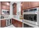 Close-up of modern kitchen with stainless steel appliances, white backsplash, and wood cabinetry at 3929 Reyes Ave, Las Vegas, NV 89141