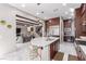 Kitchen featuring stainless steel appliances, a spacious island with seating, and rich wood cabinetry at 3929 Reyes Ave, Las Vegas, NV 89141