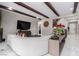 Living room with a textured accent wall, white sofas, and wooden beam ceilings at 3929 Reyes Ave, Las Vegas, NV 89141