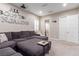 Comfortable living room with a grey sectional couch, and light beige walls at 3929 Reyes Ave, Las Vegas, NV 89141