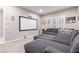 Living room featuring a large grey sectional couch and a blank projector screen at 3929 Reyes Ave, Las Vegas, NV 89141