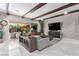 Open living room with wood beam ceilings, modern furnishings, and sliding glass doors to the patio at 3929 Reyes Ave, Las Vegas, NV 89141
