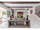 Bright living room featuring stylish decor, wood beam ceilings, and access to the backyard at 3929 Reyes Ave, Las Vegas, NV 89141