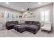 Spacious living room featuring a grey sectional couch and plenty of natural light at 3929 Reyes Ave, Las Vegas, NV 89141