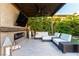 Cozy outdoor fireplace with a TV and comfortable lounge seating at 3929 Reyes Ave, Las Vegas, NV 89141