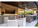 Stylish outdoor kitchen with a built-in grill, refrigerator, and bar area at 3929 Reyes Ave, Las Vegas, NV 89141