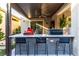 Well-equipped outdoor kitchen featuring a grill, bar seating, and modern appliances at 3929 Reyes Ave, Las Vegas, NV 89141