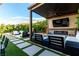Beautiful outdoor living space with a fireplace, TV, and luxurious seating at 3929 Reyes Ave, Las Vegas, NV 89141