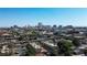 An aerial view shows nearby apartment buildings with a distant view of the city skyline at 4 Britz Cir, North Las Vegas, NV 89030