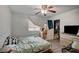 A small bedroom includes a closet with hanging clothes, window, and a ceiling fan at 4 Britz Cir, North Las Vegas, NV 89030