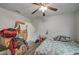 Small bedroom includes window and ceiling fan with hardwood flooring and large pile of boxes at 4 Britz Cir, North Las Vegas, NV 89030
