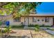 Charming front exterior featuring secure windows, a security door, with a small outdoor seating area at 4 Britz Cir, North Las Vegas, NV 89030