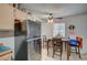 Kitchen with tile floors, ceiling fan, and modern black refrigerator and cabinets at 4 Britz Cir, North Las Vegas, NV 89030