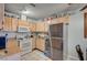 Functional kitchen featuring light wood cabinetry, stainless steel refrigerator, and tiled floors at 4 Britz Cir, North Las Vegas, NV 89030