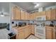 Well-lit kitchen featuring ample counter space, matching appliances, and updated flooring at 4 Britz Cir, North Las Vegas, NV 89030
