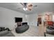 Spacious living room with tile flooring, contemporary ceiling fan, and ample natural light at 4 Britz Cir, North Las Vegas, NV 89030