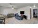 Open-concept living area with tile floors and comfortable seating, perfect for relaxation and entertainment at 4 Britz Cir, North Las Vegas, NV 89030