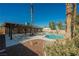 Spacious backyard with a pool, spa, a covered patio, surrounded by mature landscaping at 4016 Tyler William Ln, Las Vegas, NV 89130