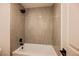 Bathroom features a bathtub and shower with modern beige tiling and black hardware at 4016 Tyler William Ln, Las Vegas, NV 89130