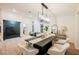 Bright dining room with modern chandelier, stylish furniture, and sliding glass doors at 4016 Tyler William Ln, Las Vegas, NV 89130