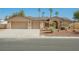 Well-maintained home with desert landscaping, a two-car garage, and a spacious driveway at 4016 Tyler William Ln, Las Vegas, NV 89130
