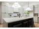 Modern kitchen boasts a large center island with seating, stylish pendant lighting, and lots of custom cabinetry at 4016 Tyler William Ln, Las Vegas, NV 89130