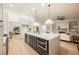 Open-concept kitchen showcases a large island with seating, modern appliances, and seamless flow to the living area at 4016 Tyler William Ln, Las Vegas, NV 89130