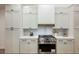 Bright kitchen features stainless steel appliances, white cabinetry, and stylish backsplash for a clean aesthetic at 4016 Tyler William Ln, Las Vegas, NV 89130
