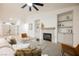 Relaxing living room featuring a fireplace, vaulted ceilings, and built-in shelving offering both style and functionality at 4016 Tyler William Ln, Las Vegas, NV 89130