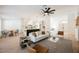 Open-concept living room featuring modern furniture, a ceiling fan, and natural light at 4016 Tyler William Ln, Las Vegas, NV 89130