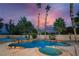 Inviting backyard pool and spa oasis surrounded by mature landscaping and palm trees at 4016 Tyler William Ln, Las Vegas, NV 89130